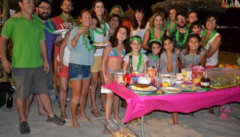 La Sombrillada nocturna de les festes de s'lllot uneix tota una munió de veïns per sopar i gaudir de la nit damunt l'arena
